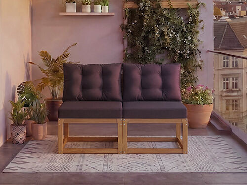 Двуместен модулен дървен диван с тъмносиви възглавници на балкон, заобиколен от саксийни растения и изглед към града на заден план